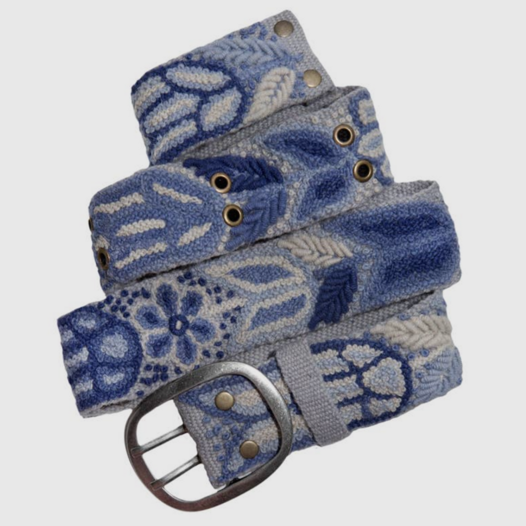 Demure floral motif handwoven belt in wool fabrication with metal buckle.  Denim hues with various of shades of blue and white.