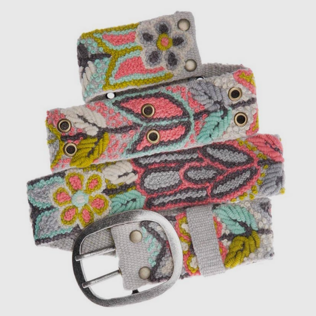 Colorful floral motif handwoven belt in wool fabrication with metal buckle. Colors include muted grey, coral, seafoam, and apple green.  